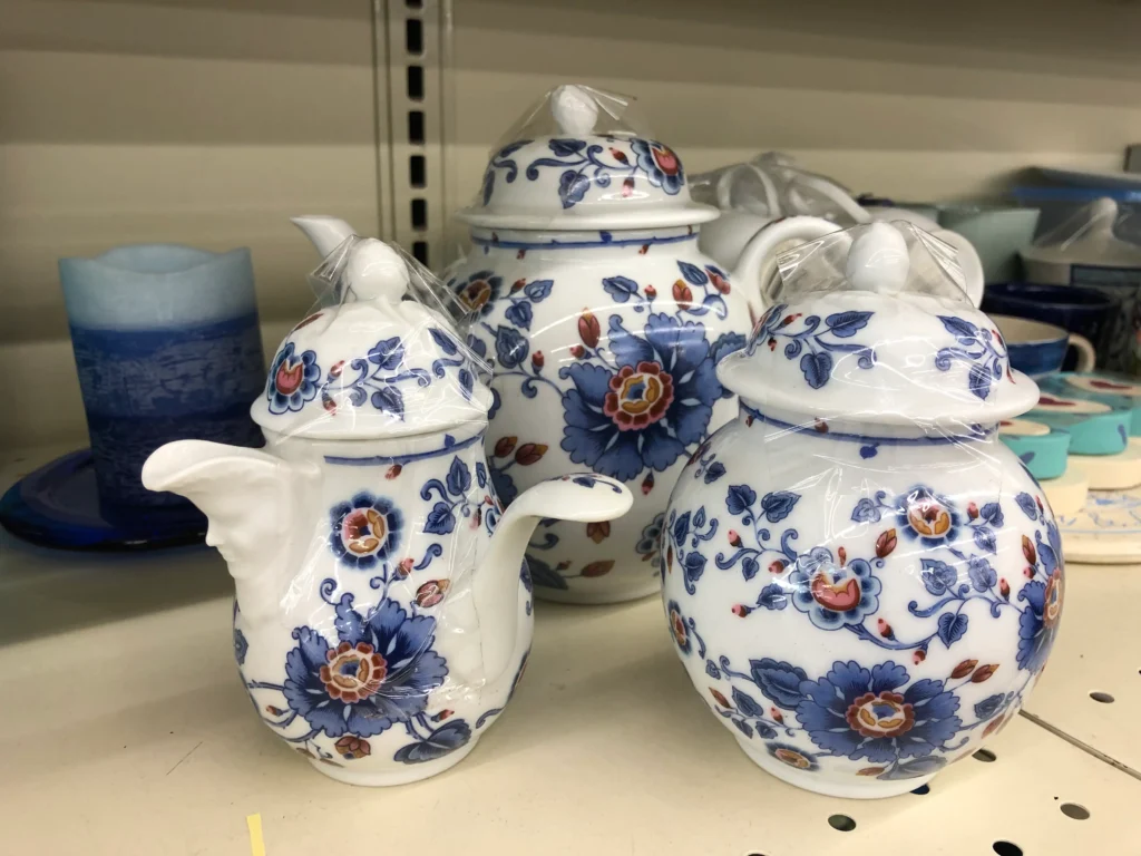 Blue and white floral porcelain teapots displayed on a shelf at Value World in North Randall.