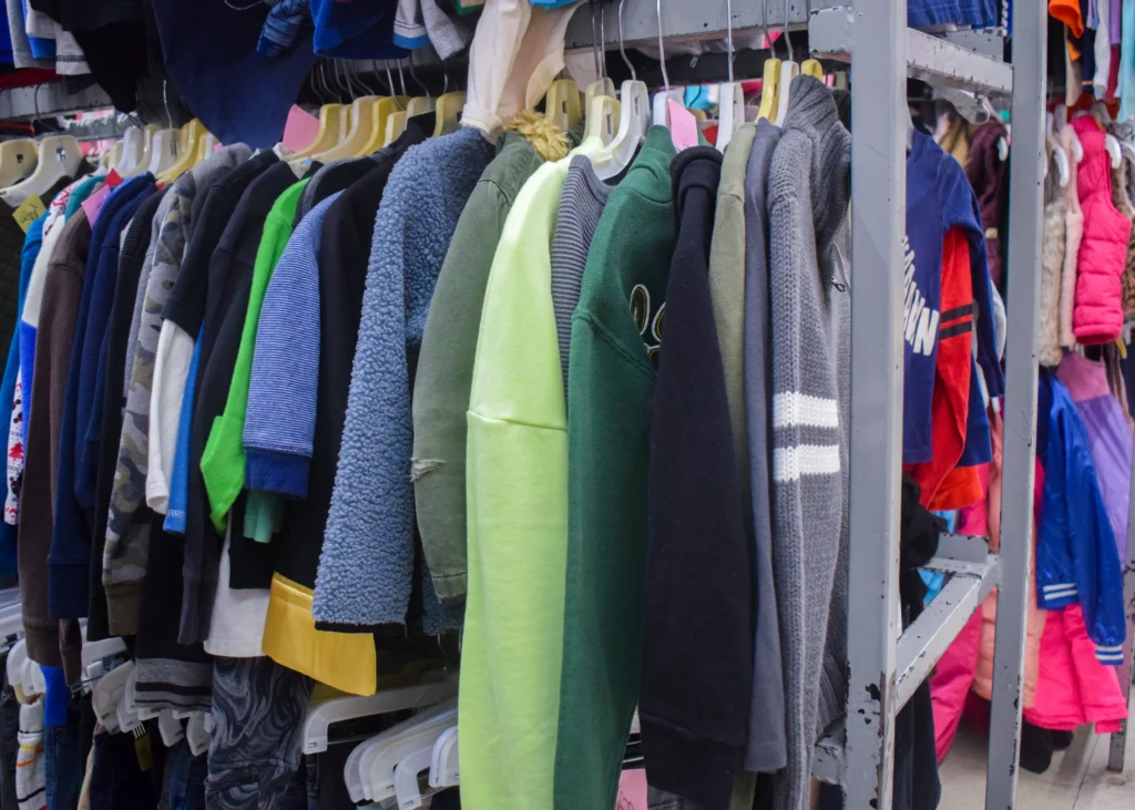 Wide view of the boys’ clothing section with organized racks of shirts, pants, and shoes inside Value World.