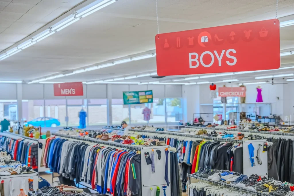 Interior view of the boys’ department with racks of clothing and shoes inside Value World.
