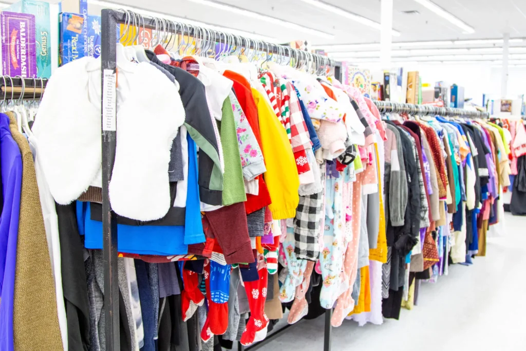 Racks filled with colorful children’s clothing, pajamas, sweaters, and seasonal outfits inside Value World.