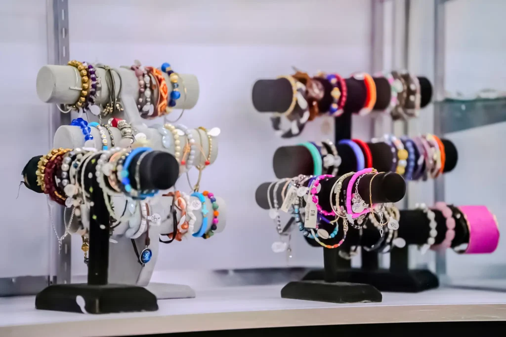 Colorful bracelets and jewelry arranged on display stands inside Value World in Ypsilanti.