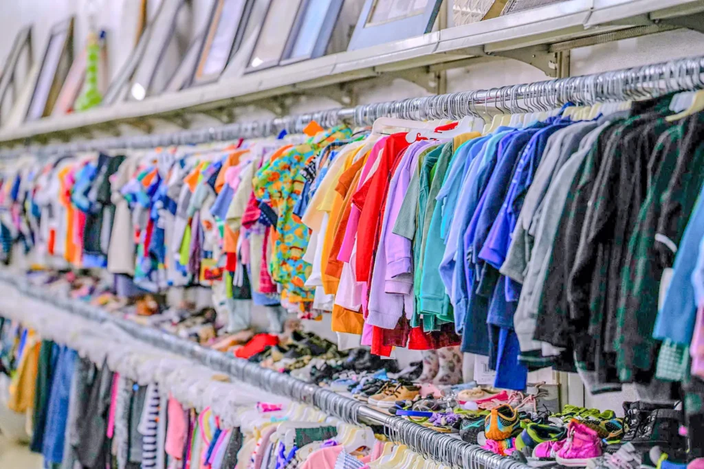 Colorful children’s shirts, outfits, and shoes displayed inside the Value World Ypsilanti store.