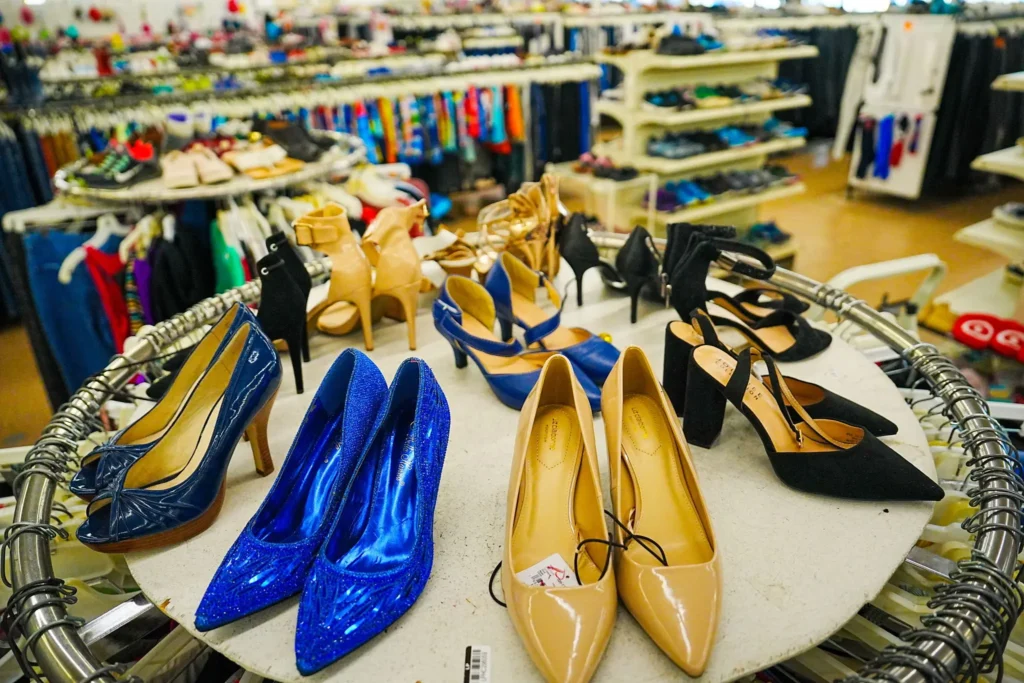 Blue, tan, black, and neutral women’s dress shoes and heels arranged on a display inside Value World.