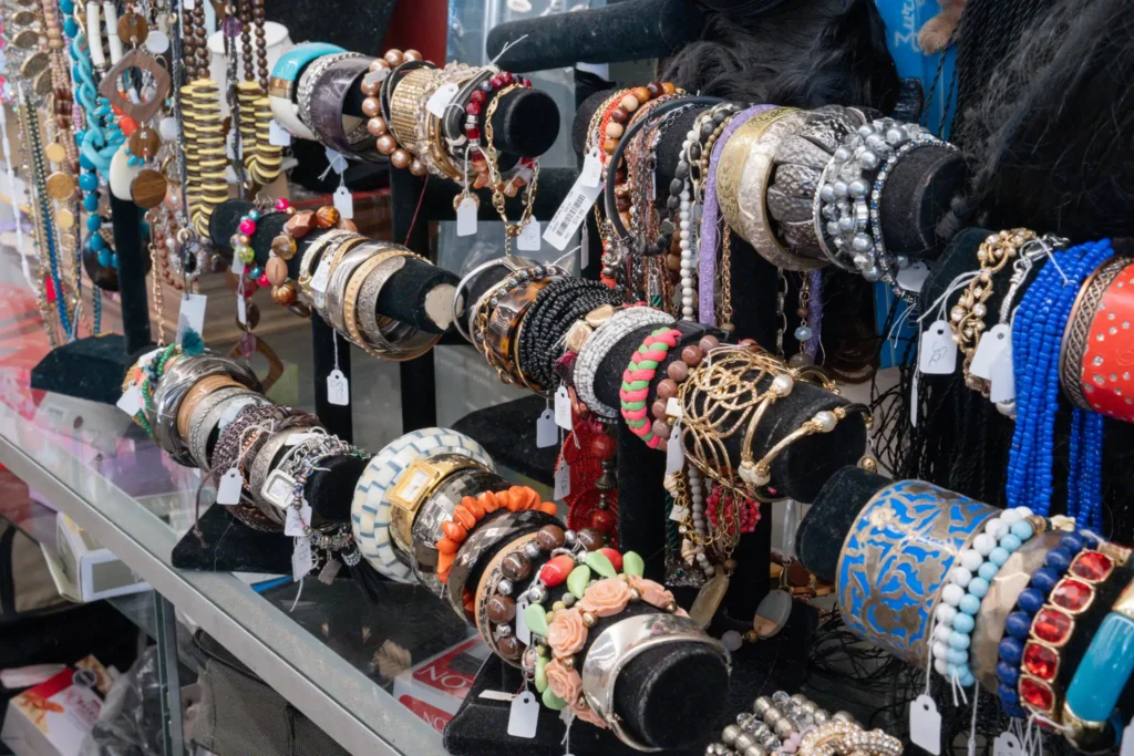 Assorted secondhand bracelets, necklaces, beads, and decorative jewelry displayed at the Gessner thrift store.