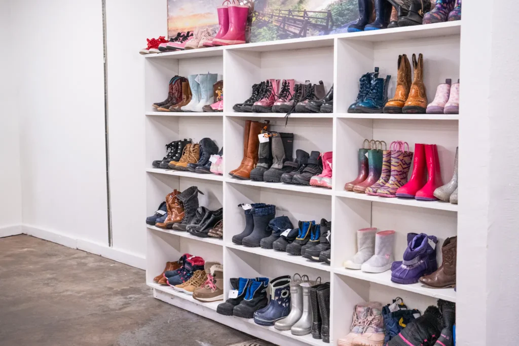 Colorful children’s rain boots, winter boots, and cowboy boots displayed at the Value World Jensen location in Houston.