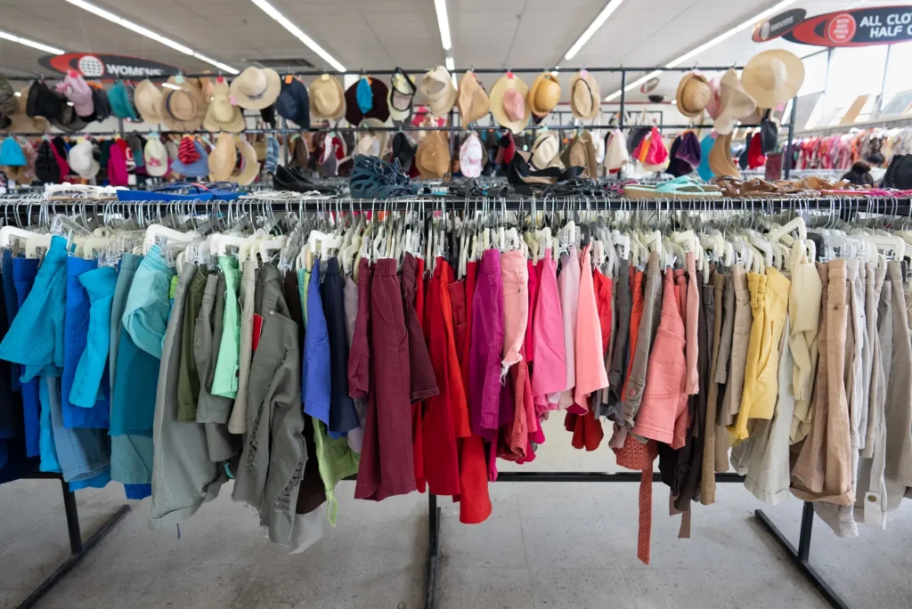 Colorful women’s shorts displayed beneath rows of shoes and hats inside the Lakewood location.