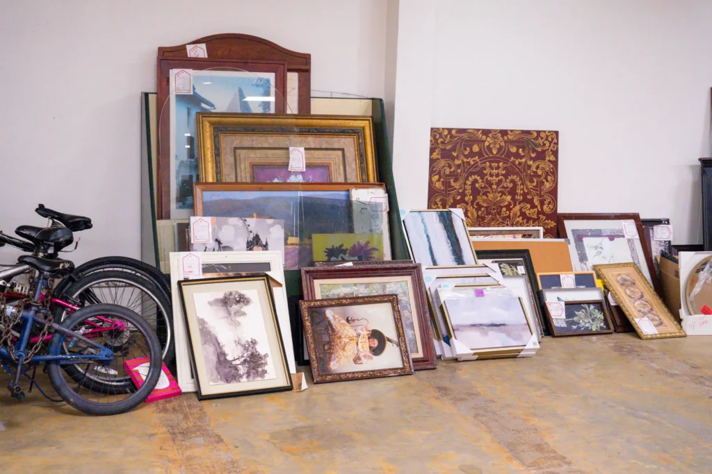Assorted framed artwork and bicycles displayed in the home décor section of the Jensen location.