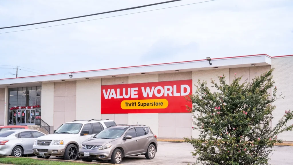 Exterior of the Value World Jensen thrift store in Houston with the entrance, store sign, and parked cars.