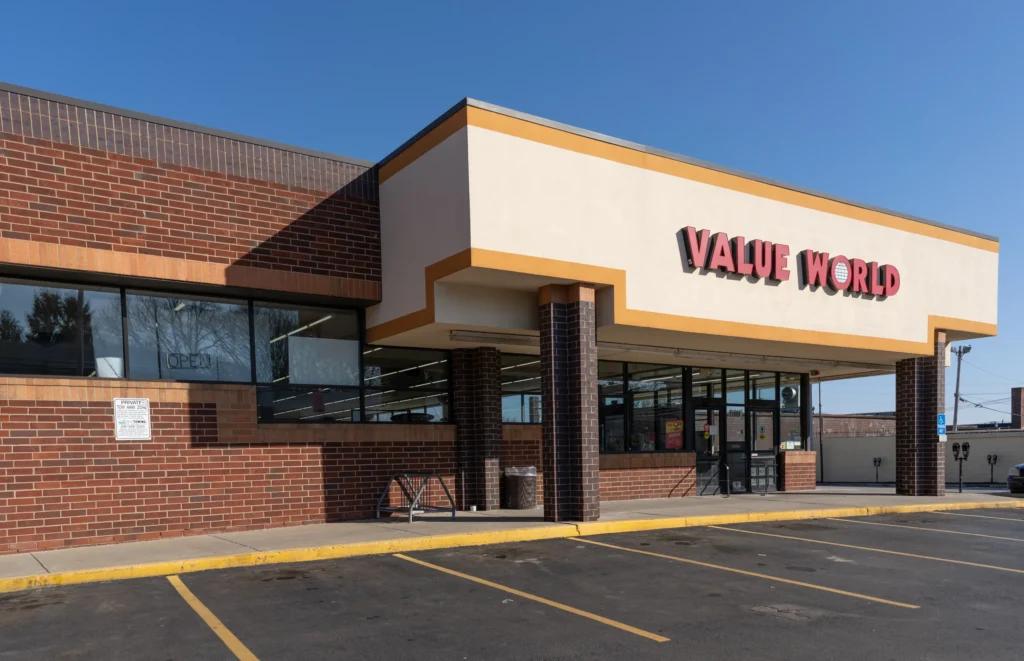 Exterior entrance of the Value World Lakewood thrift store in Ohio with brick walls and red storefront signage.
