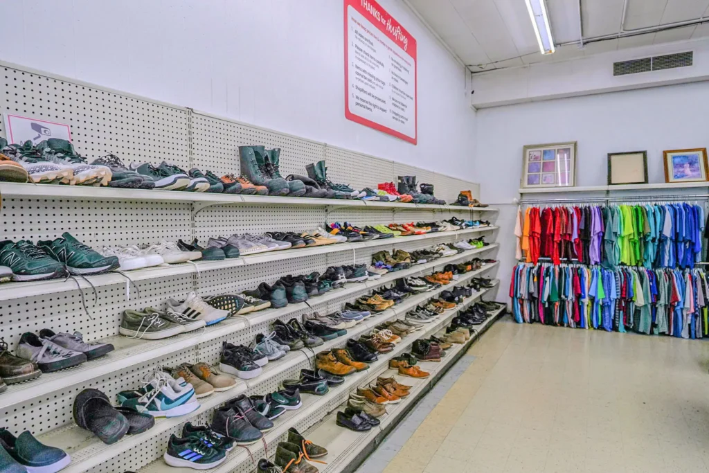 Rows of men’s shoes displayed beside colorful clothing racks inside Value World in Ypsilanti.