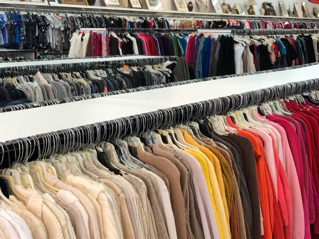 Rows of secondhand sweaters and clothing organized throughout Value World in North Randall, Ohio.