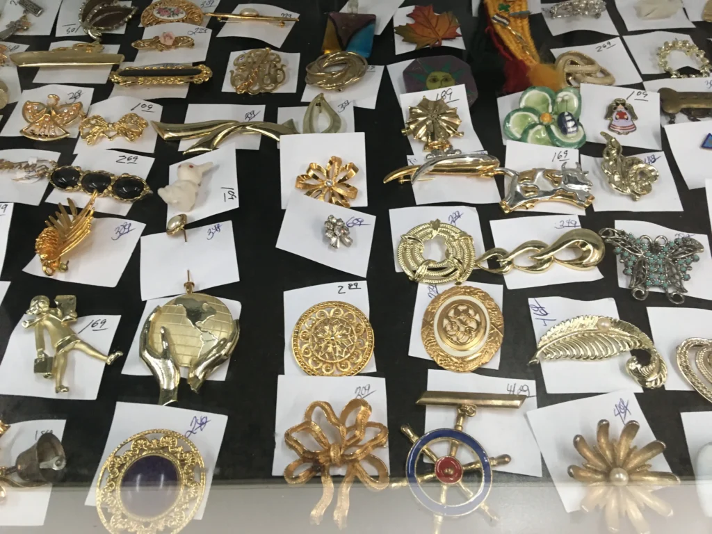 Assorted vintage brooches and decorative pins displayed at Value World in North Randall, Ohio.