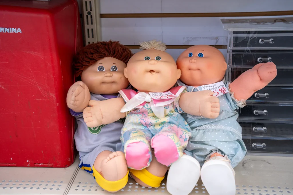 Three vintage Cabbage Patch Kids dolls displayed inside the Value World Antoine store in Houston.
