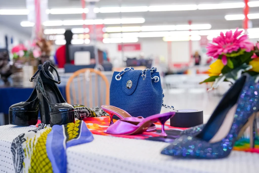 Women’s high heels and a blue handbag arranged on a display inside Value World.