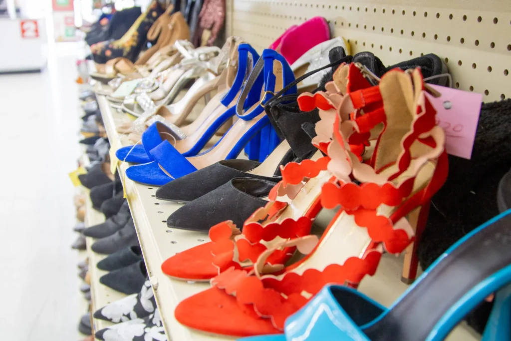 Colorful women’s heels, sandals, and dress shoes displayed on shelves inside Value World.
